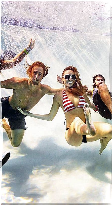 young people under water laughing