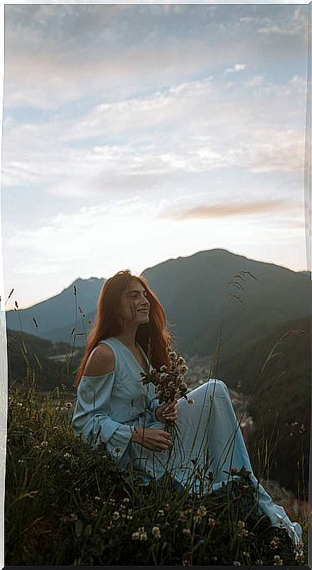 Woman with flowers in the mountain